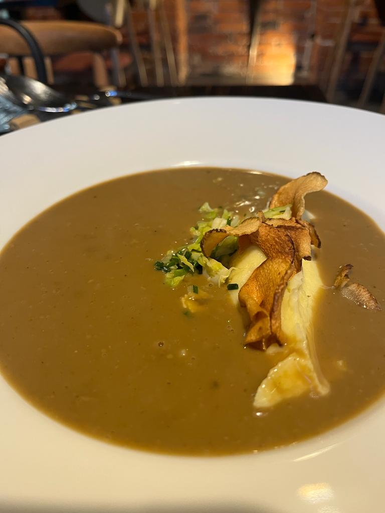 Zupa grzybowa z puree ziemniaczanym i czipsem z topinamburu w głębokim talerzu
